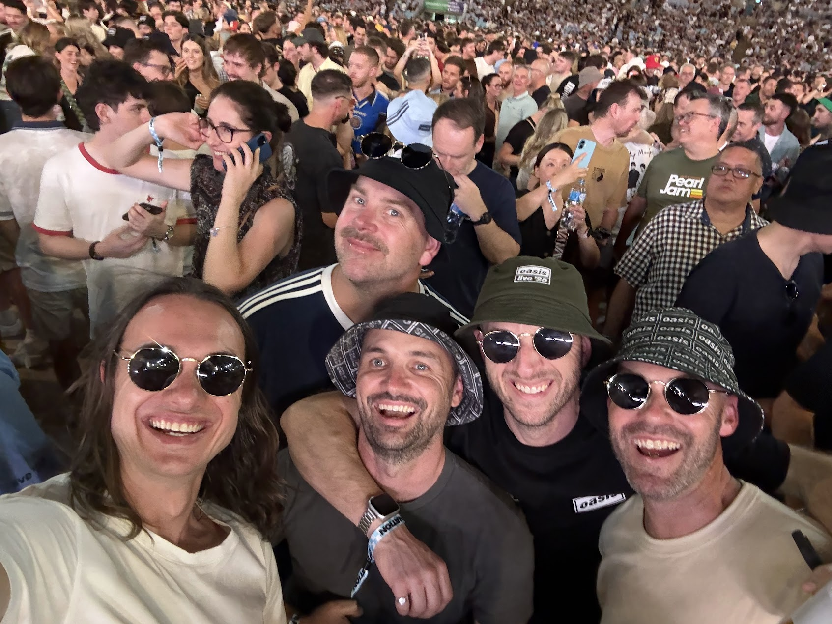 The five friends together at a concert